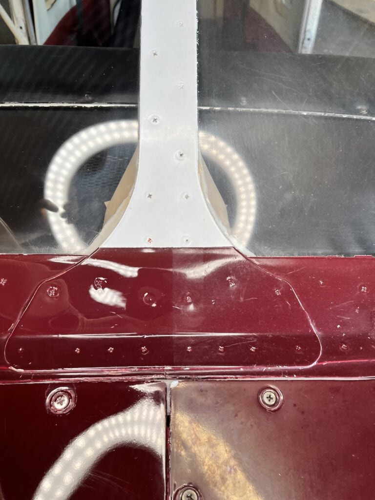 side by side showing aircraft window and paint repair